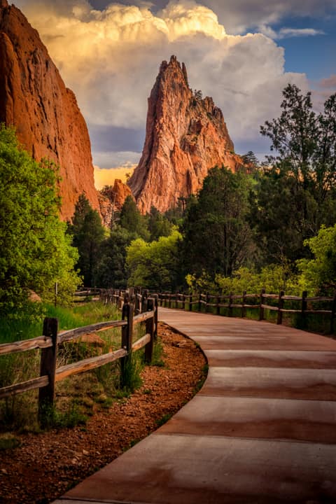 Paved trail and a red rock spire at Garden of the Gods in Colorado Springs